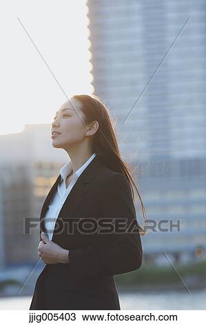 Portrait of young Japanese businesswoman by a river downtown Tokyo View Large Photo Image Stock Image - Portrait of young Japanese businesswoman by a river downtown Tokyo. Fotosearch