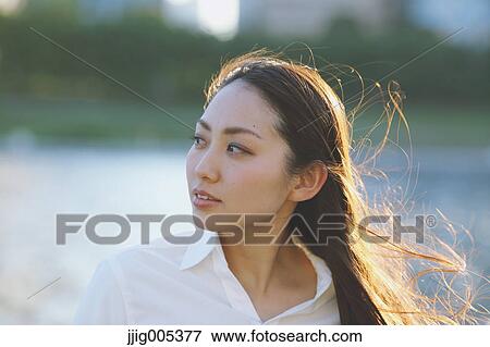 Portrait of young Japanese businesswoman by a river downtown Tokyo View Large Photo Image Stock Photo - Portrait of young Japanese businesswoman by a river downtown Tokyo. Fotosearch