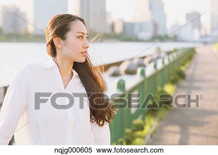 Portrait of young Japanese businesswoman by a river downtown Tokyo View Large Photo Image Stock Photography - Portrait of young Japanese businesswoman by a river downtown Tokyo. Fotosearch