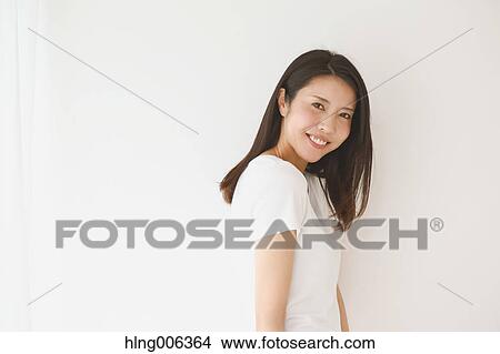 Portrait of young Japanese woman in a white room View Large Photo Image Picture - Portrait of young Japanese woman in a white room. Fotosearch