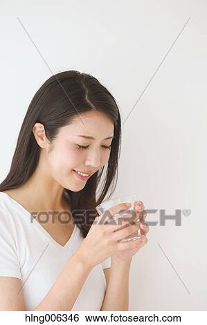Portrait of young Japanese woman in a white room View Large Photo Image Stock Photograph - Portrait of young Japanese woman in a white room. Fotosearch