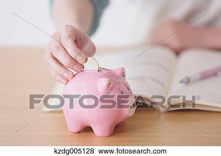 Stock Photo - Senior Japanese woman doing accounting in the living room. Fotosearch