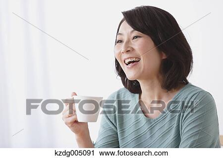 Senior Japanese woman having coffee in the living room View Large Photo Image Stock Image - Senior Japanese woman having coffee in the living room. Fotosearch