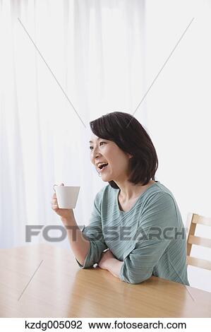 Senior Japanese woman having coffee in the living room View Large Photo Image Stock Image - Senior Japanese woman having coffee in the living room. Fotosearch