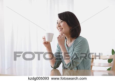 Senior Japanese woman having coffee in the living room View Large Photo Image Stock Image - Senior Japanese woman having coffee in the living room. Fotosearch