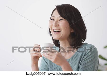 Senior Japanese woman having coffee in the living room View Large Photo Image Stock Photo - Senior Japanese woman having coffee in the living room. Fotosearch