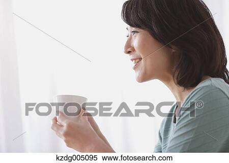 Senior Japanese woman having coffee in the living room View Large Photo Image Stock Photography - Senior Japanese woman having coffee in the living room. Fotosearch