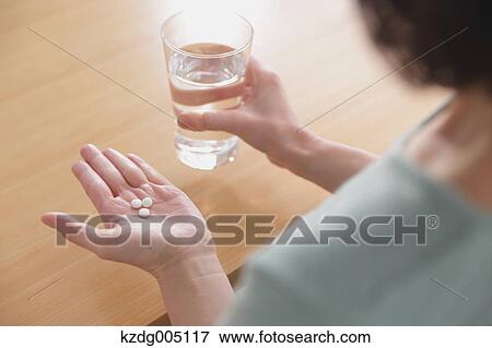 Senior Japanese woman taking pills in the living room View Large Photo Image Stock Photo - Senior Japanese woman taking pills in the living room. Fotosearch