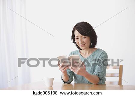 Senior Japanese woman with book in the living room View Large Photo Image Stock Photo - Senior Japanese woman with book in the living room. Fotosearch