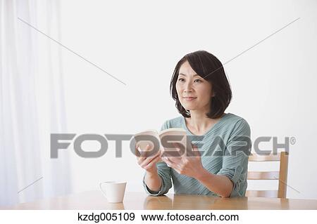 Senior Japanese woman with book in the living room View Large Photo Image Stock Photo - Senior Japanese woman with book in the living room. Fotosearch
