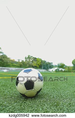 Stock Image - Soccer ball on grass. Fotosearch