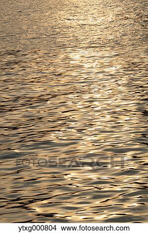 Sunlight reflecting on water View Large Photo Image Picture - Sunlight reflecting on water. Fotosearch