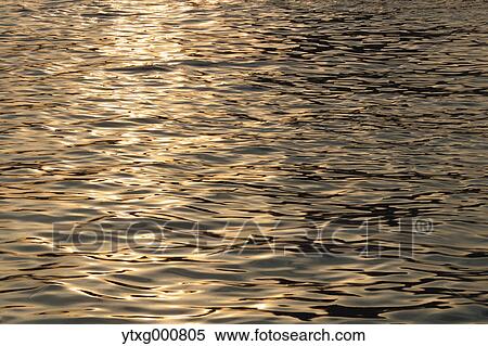 Sunlight reflecting on water View Large Photo Image Stock Photography - Sunlight reflecting on water. Fotosearch