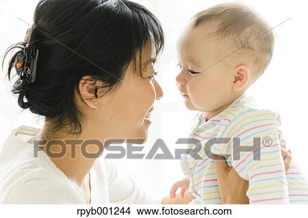 Picture - Toddler with mum in the house. Fotosearch