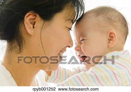 Stock Image - Toddler with mum in the house. Fotosearch