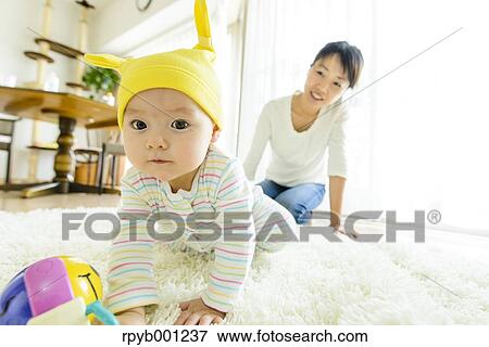 Stock Photo - Toddler with mum in the house. Fotosearch