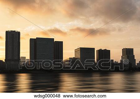 Tokyo cityscape at sunset from Tsukishima, Tokyo, Japan View Large Photo Image Stock Photo - Tokyo cityscape at sunset from Tsukishima, Tokyo, Japan. Fotosearch