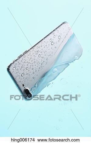 Waterproof smartphone covered with water View Large Photo Image Picture - Waterproof smartphone covered with water. Fotosearch