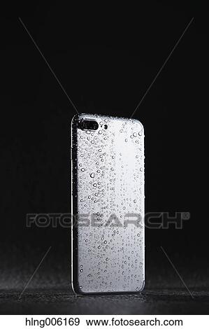 Waterproof smartphone covered with water View Large Photo Image Stock Photo - Waterproof smartphone covered with water. Fotosearch