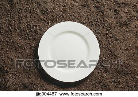 White plate on soil View Large Photo Image Stock Photo - White plate on soil. Fotosearch