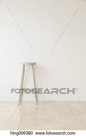 Stock Image - Wooden chair in a white room. Fotosearch