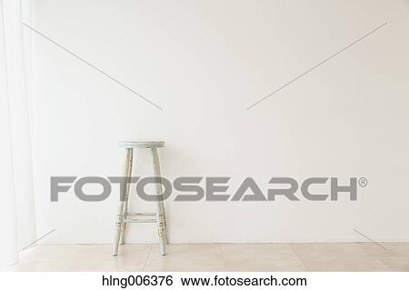 Wooden chair in a white room View Large Photo Image Stock Photograph - Wooden chair in a white room. Fotosearch