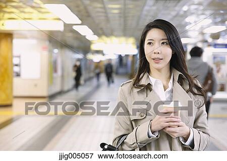 Young attractive Japanese woman at underground train station View Large Photo Image Stock Photo - Young attractive Japanese woman at underground train station. Fotosearch