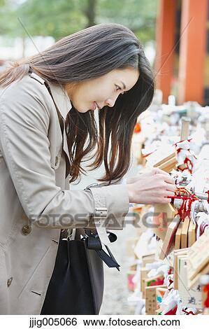Young attractive Japanese woman at the temple View Large Photo Image Stock Photograph - Young attractive Japanese woman at the temple. Fotosearch
