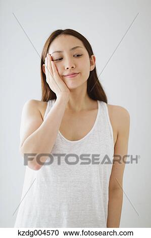 Young attractive Japanese woman doing skin care in the bathroom View Large Photo Image Stock Image - Young attractive Japanese woman doing skin care in the bathroom. Fotosearch