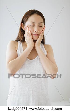 Young attractive Japanese woman doing skin care in the bathroom View Large Photo Image Stock Image - Young attractive Japanese woman doing skin care in the bathroom. Fotosearch