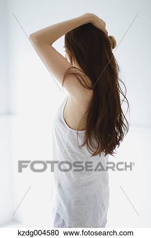 Young attractive Japanese woman doing her hair in the bathroom View Large Photo Image Stock Image - Young attractive Japanese woman doing her hair in the bathroom. Fotosearch