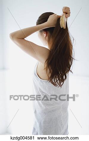 Young attractive Japanese woman doing her hair in the bathroom View Large Photo Image Stock Image - Young attractive Japanese woman doing her hair in the bathroom. Fotosearch