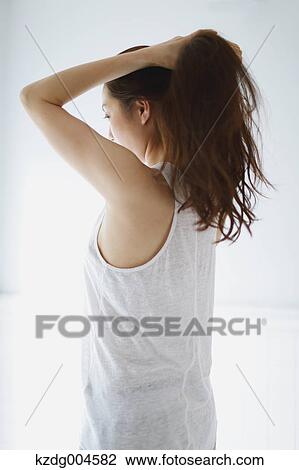 Young attractive Japanese woman doing her hair in the bathroom View Large Photo Image Stock Image - Young attractive Japanese woman doing her hair in the bathroom. Fotosearch