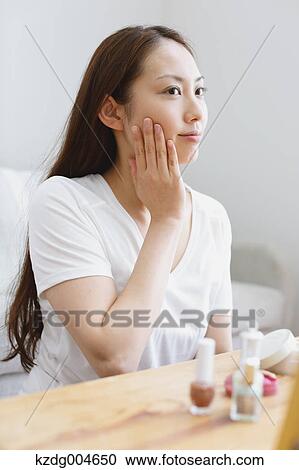 Young attractive Japanese woman doing her make-up at home View Large Photo Image Stock Image - Young attractive Japanese woman doing her make-up at home. Fotosearch