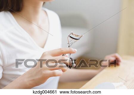 Young attractive Japanese woman doing her make-up at home View Large Photo Image Stock Image - Young attractive Japanese woman doing her make-up at home. Fotosearch