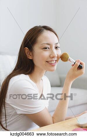 Young attractive Japanese woman doing her make-up at home View Large Photo Image Stock Image - Young attractive Japanese woman doing her make-up at home. Fotosearch