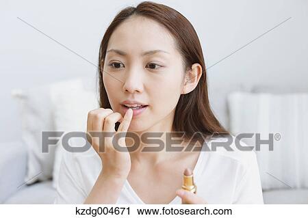 Young attractive Japanese woman doing her make-up at home View Large Photo Image Stock Image - Young attractive Japanese woman doing her make-up at home. Fotosearch