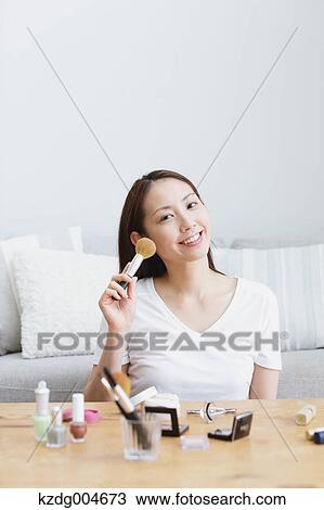 Young attractive Japanese woman doing her make-up at home View Large Photo Image Stock Image - Young attractive Japanese woman doing her make-up at home. Fotosearch