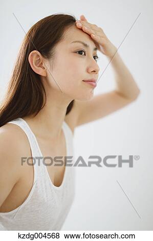 Young attractive Japanese woman doing skin care in the bathroom View Large Photo Image Stock Photo - Young attractive Japanese woman doing skin care in the bathroom. Fotosearch