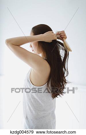 Young attractive Japanese woman doing her hair in the bathroom View Large Photo Image Stock Photo - Young attractive Japanese woman doing her hair in the bathroom. Fotosearch