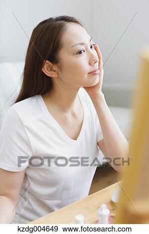 Young attractive Japanese woman doing her make-up at home View Large Photo Image Stock Photo - Young attractive Japanese woman doing her make-up at home. Fotosearch
