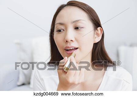 Young attractive Japanese woman doing her make-up at home View Large Photo Image Stock Photo - Young attractive Japanese woman doing her make-up at home. Fotosearch