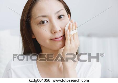 Young attractive Japanese woman doing her make-up at home View Large Photo Image Stock Photograph - Young attractive Japanese woman doing her make-up at home. Fotosearch