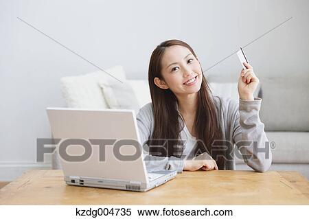 Young attractive Japanese woman doing online shopping at home View Large Photo Image Stock Photography - Young attractive Japanese woman doing online shopping at home. Fotosearch