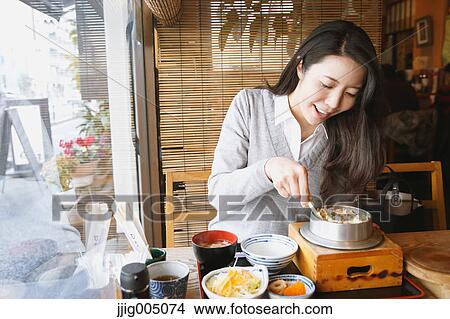 Young attractive Japanese woman eating at the restaurant View Large Photo Image Picture - Young attractive Japanese woman eating at the restaurant. Fotosearch