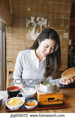 Young attractive Japanese woman eating at the restaurant View Large Photo Image Stock Image - Young attractive Japanese woman eating at the restaurant. Fotosearch