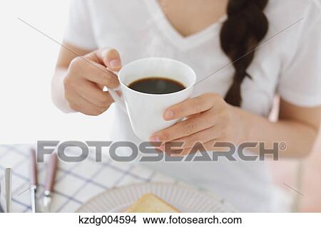 Young attractive Japanese woman having breakfast at home View Large Photo Image Picture - Young attractive Japanese woman having breakfast at home. Fotosearch