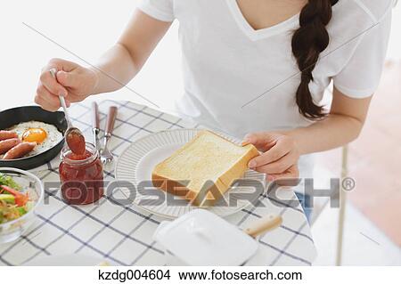 Young attractive Japanese woman having breakfast at home View Large Photo Image Picture - Young attractive Japanese woman having breakfast at home. Fotosearch
