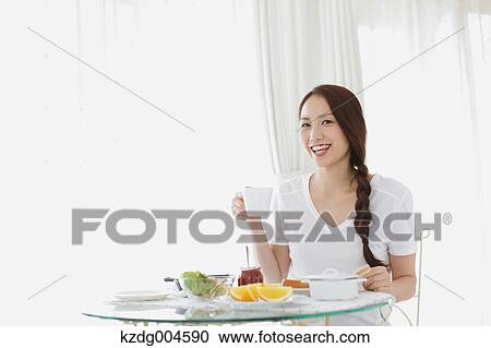 Young attractive Japanese woman having breakfast at home View Large Photo Image Stock Image - Young attractive Japanese woman having breakfast at home. Fotosearch