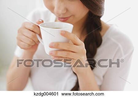 Young attractive Japanese woman having cofee at home View Large Photo Image Stock Image - Young attractive Japanese woman having cofee at home. Fotosearch